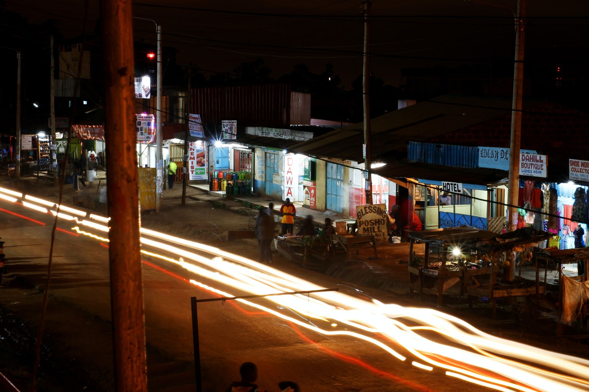 A road lined with eclectic businesses in Nairobi, at nighttim