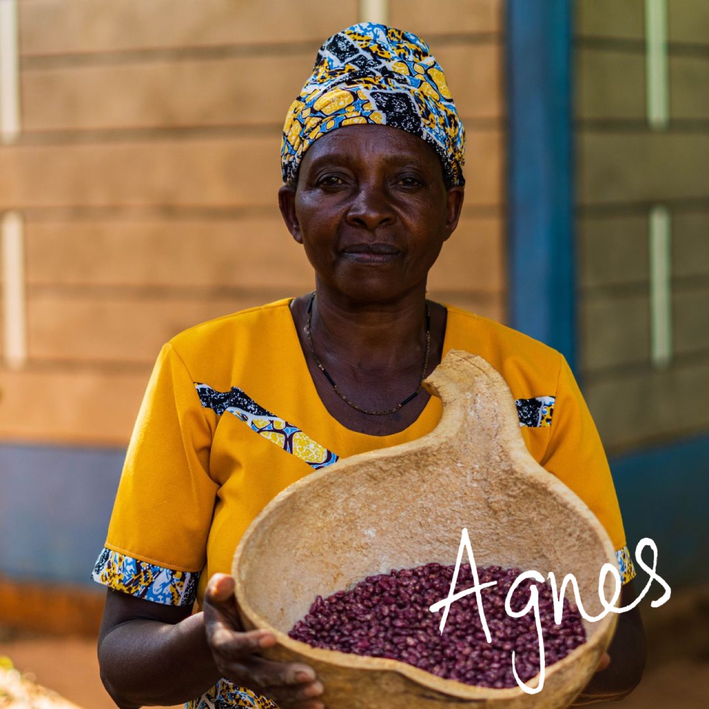 Agnes holding a gourd of beans